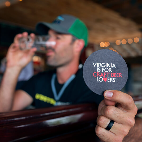 Beverage coaster with a Virginia is for lovers logo